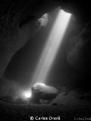 The sunlight through the siphon of El Moraig" cave in Pob... by Carlos Ortolà 